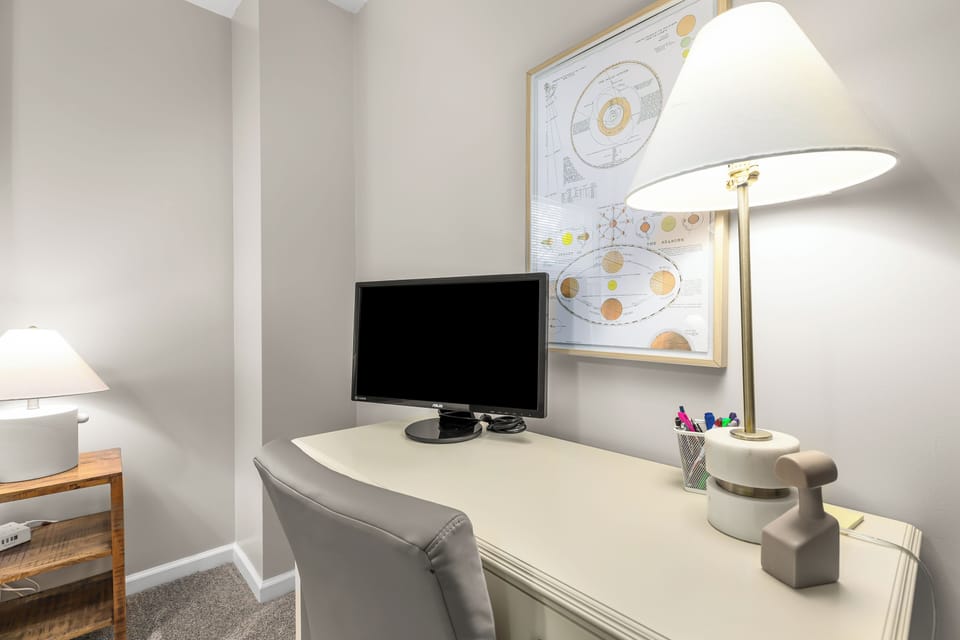 A dedicated workspace equipped with a monitor to cater to your office requirements.