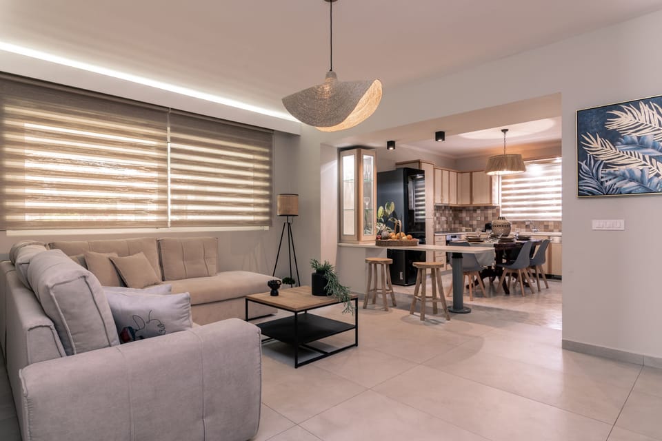 Open plan living room settings and a fully equipped kitchen.