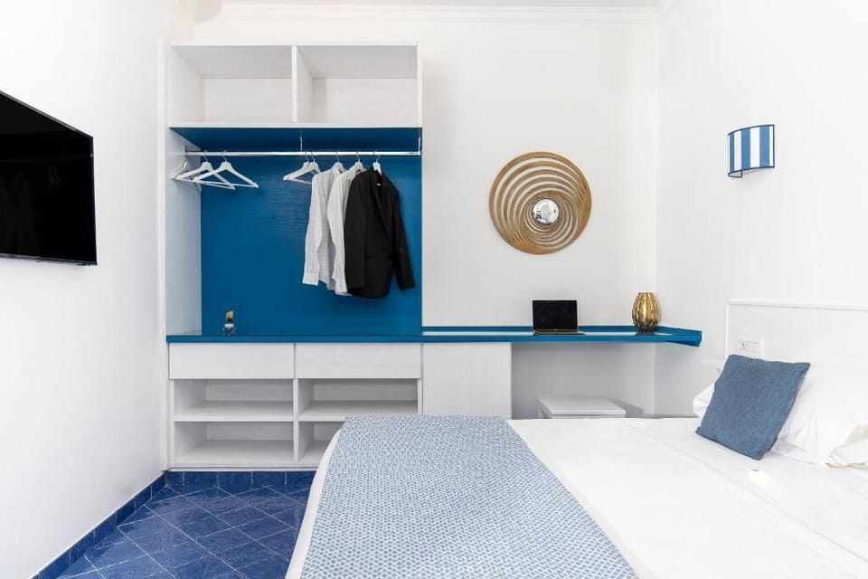 Standard Double Room, Partial Sea View | Minibar, in-room safe, desk, iron/ironing board