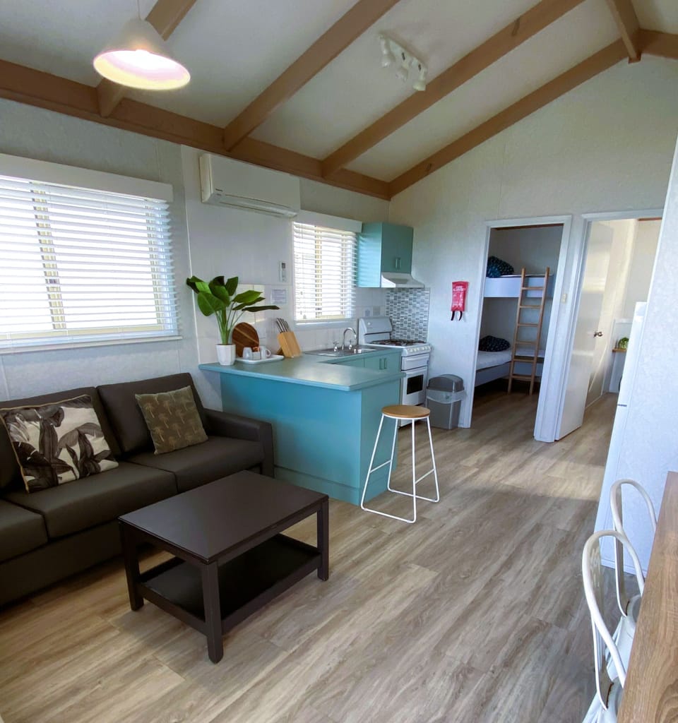 Beachfront Holiday Cabin (1 Queen, 1 Bunk and 1 Single Bed) | Living area | Flat-screen TV