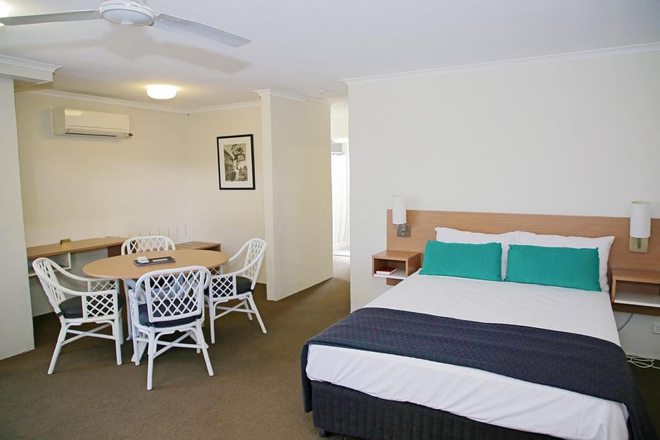 Desk, iron/ironing board, bed sheets