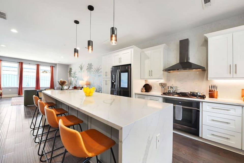 Spacious gourmet kitchen with large island, seating, and premium appliances