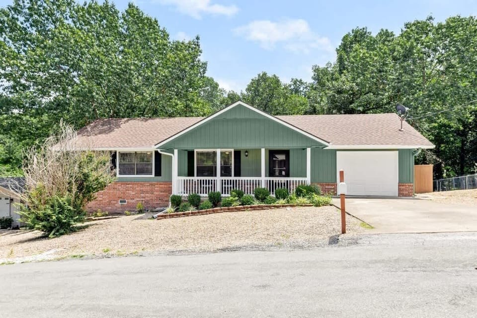 Welcome to your Bella Vista retreat—nestled among towering trees with a cozy porch and modern charm 🌳🏡
