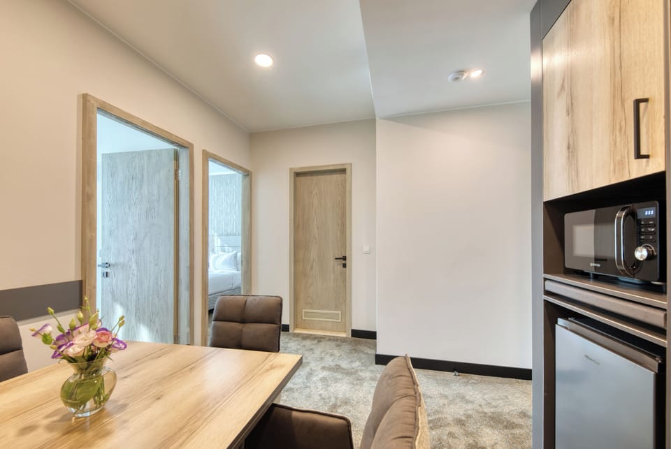 Senior Triple Room, 2 Bedrooms | Desk, laptop workspace, bed sheets