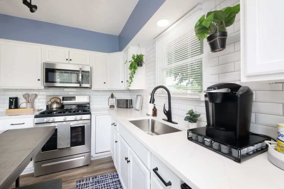 Whip up meals in this modern kitchen  Stainless steel appliances, Keurig coffee station, and tons of natural light make cooking here a joy. Fresh, functional, and fully stocked! ☕