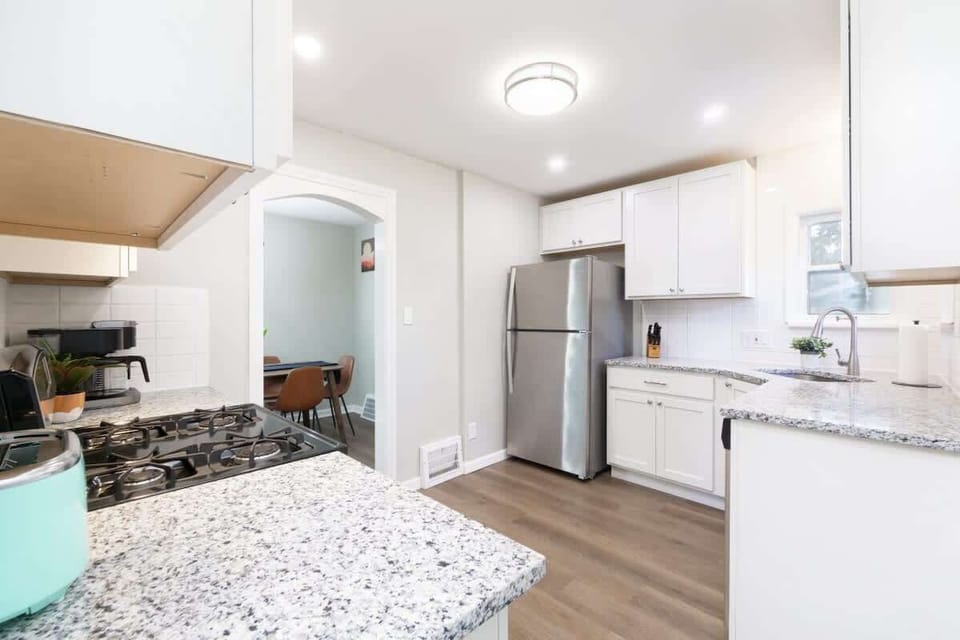- Spacious kitchen with granite countertops and bright design   - Stainless steel refrigerator and ample storage cabinets   - Open view to dining room creates connected cooking space  