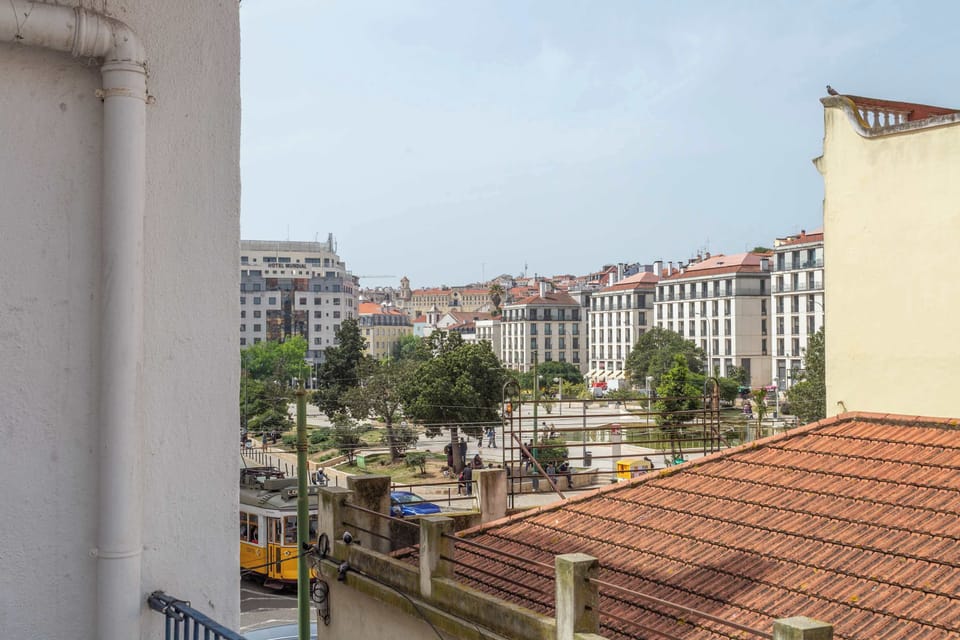 21 Tram 28 stop and Lisbon cityscape directly outside · StayInLisbon