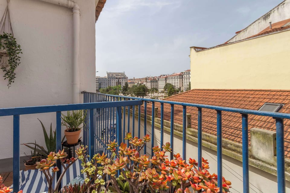 5 · Terrace railing view over Lisbon cityscape · StayInLisbon