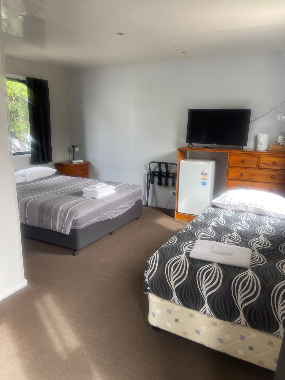 Desk, iron/ironing board, bed sheets