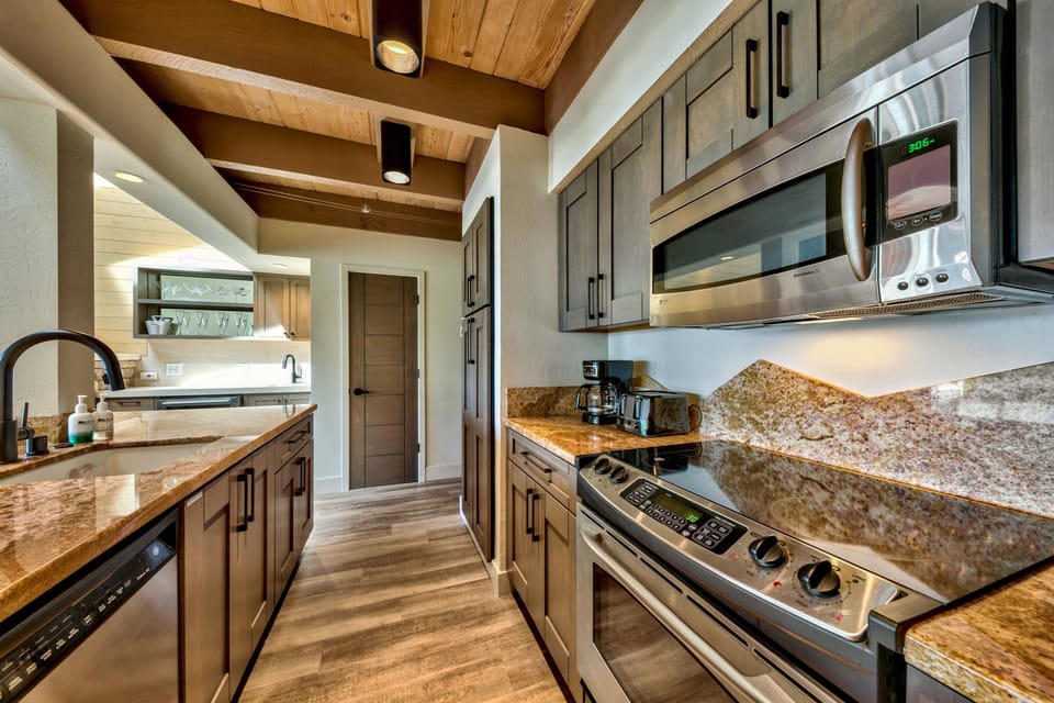 Your gourmet kitchen features granite countertops, stainless steel appliances, and rustic wood beams that create the perfect space for culinary adventures.