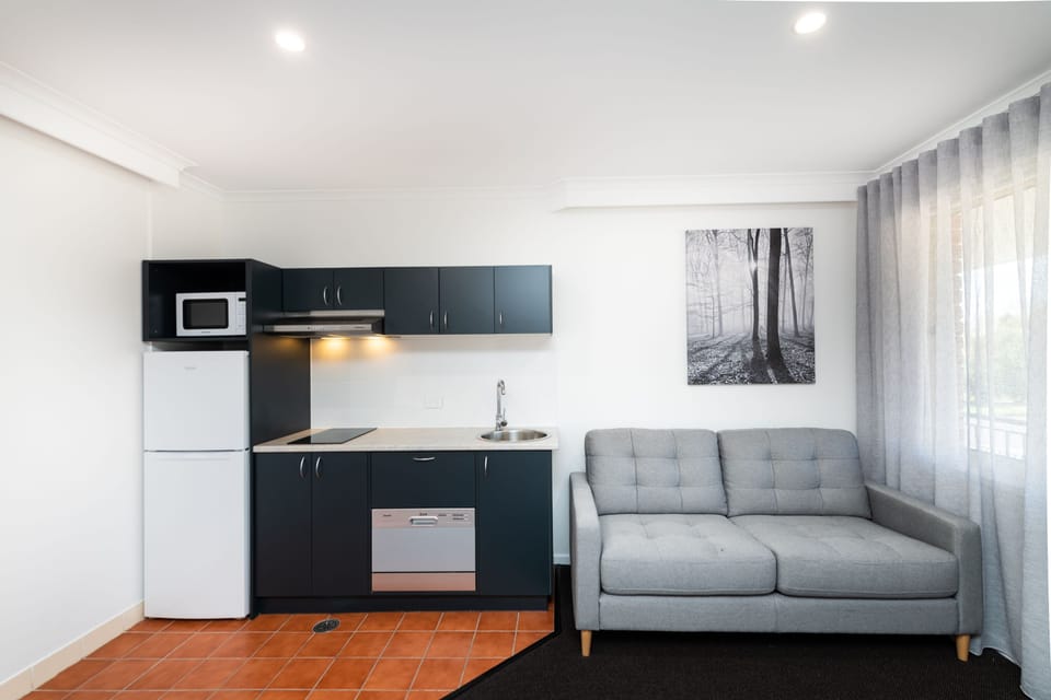 Queen Suite with Kitchen, No Pets | Living area | 40-inch TV with digital channels