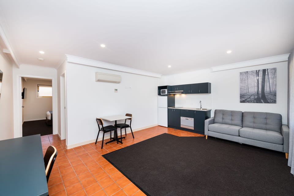 Queen Suite with Kitchen, No Pets | Living area | 40-inch TV with digital channels
