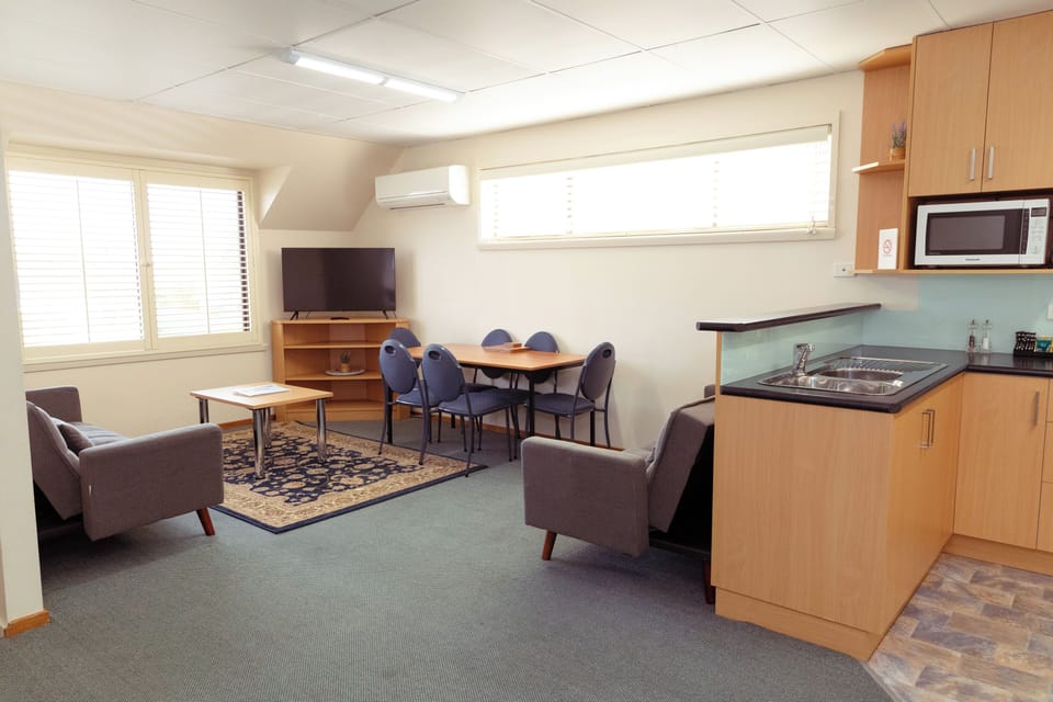 Executive Apartment | Living area | LCD TV, books