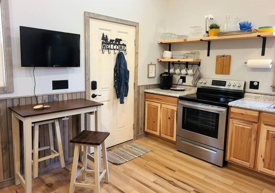 Pub dining set and fully-equipped kitchen allow for dining in.