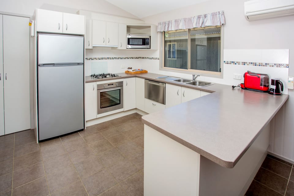 Condo Spa | Private kitchen | Coffee/tea maker, full-size fridge, microwave, stovetop
