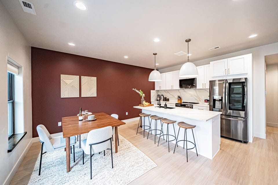 The open dining and kitchen space, located downstairs.
