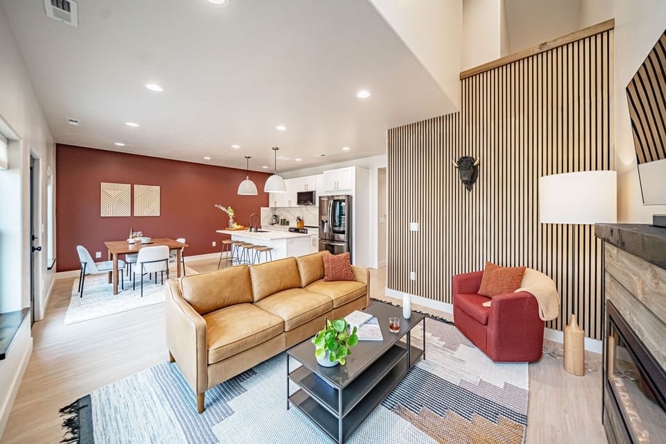 This pristine space is equipped with a leather couch & a cozy fireplace.