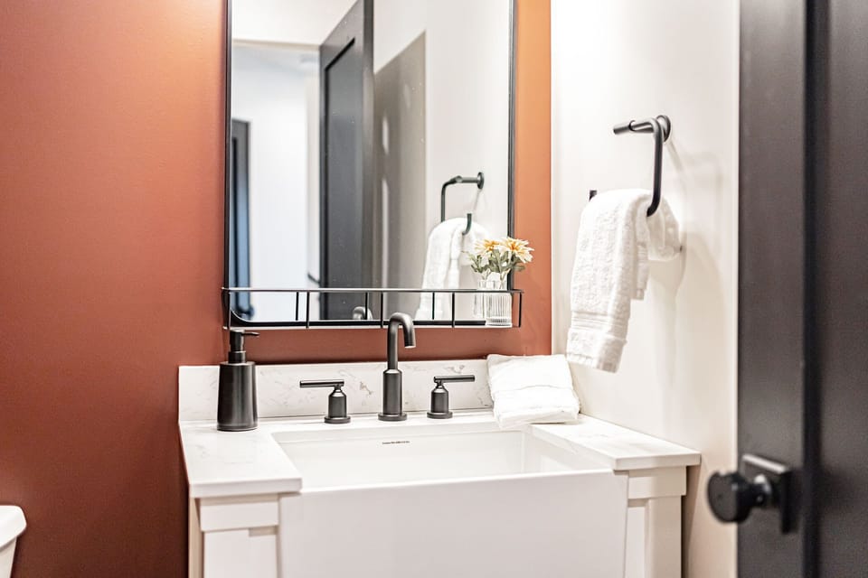 The downstairs powder room is located near the living space.