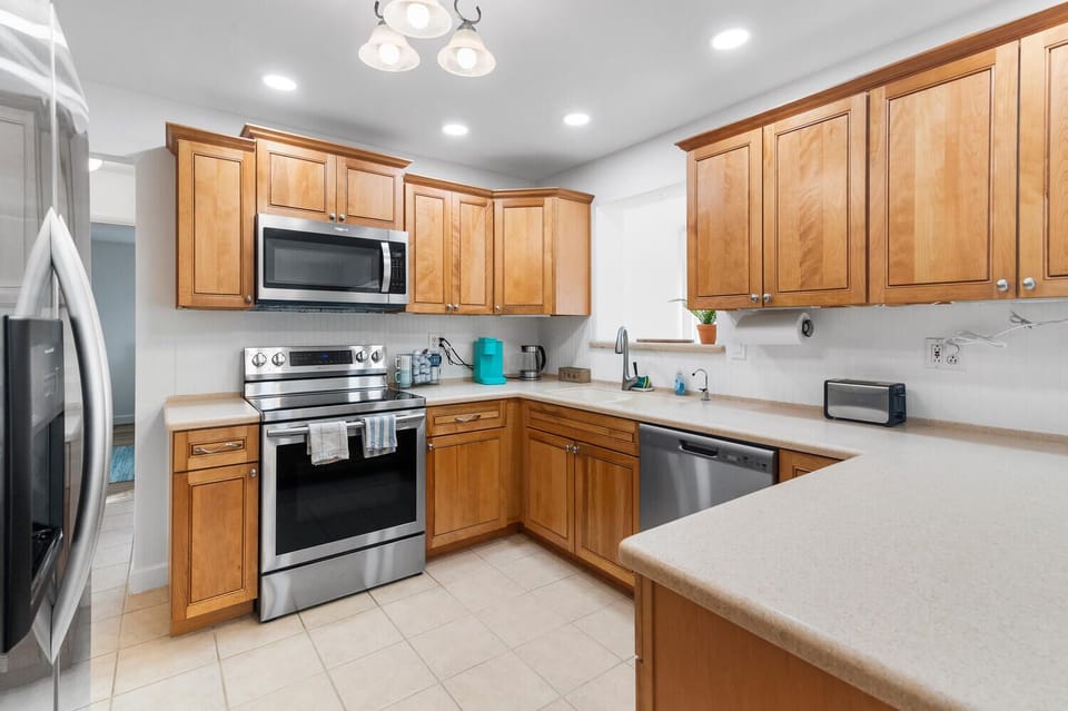 Welcome to the heart of the home! This modern kitchen features stainless steel appliances, ample counter space, and a bright, inviting atmosphere—perfect for cooking and entertaining your loved ones.