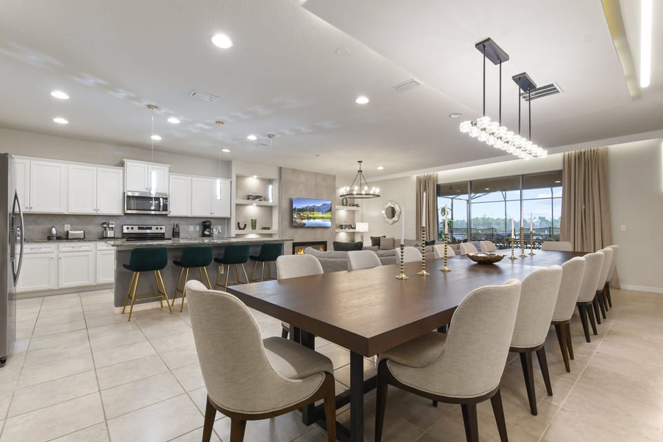 Expansive open-plan space with a modern kitchen, dining area, and cozy living room.