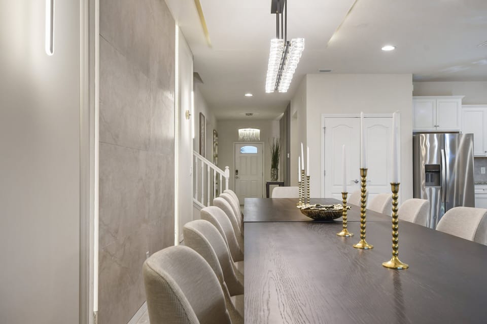 Stylish dining area with modern lighting, sleek decor, and an open layout.