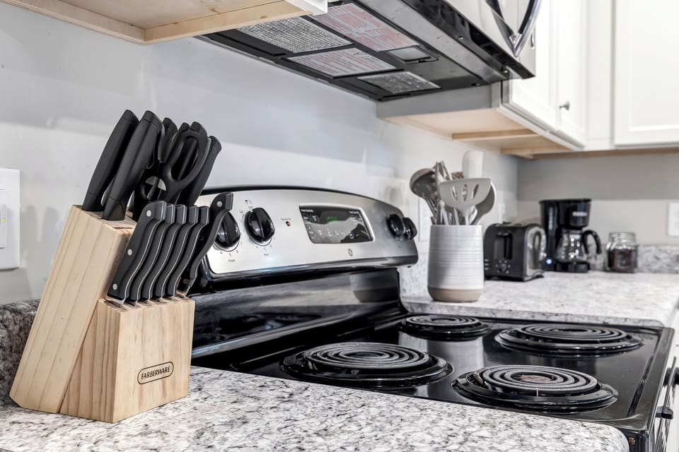 {KITCHEN} with all its sleek stainless steel appliances. 