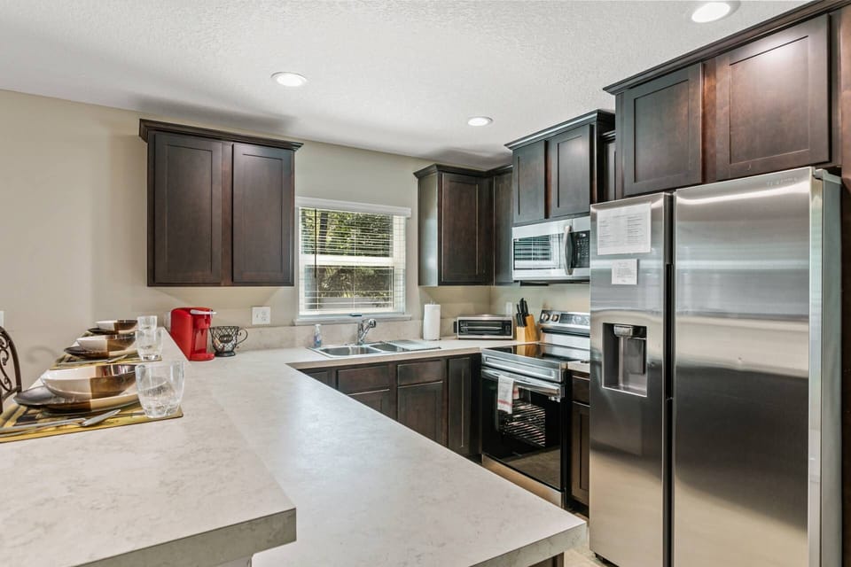 Full Kitchen with Stainless Steel Appliances and Double Sinks