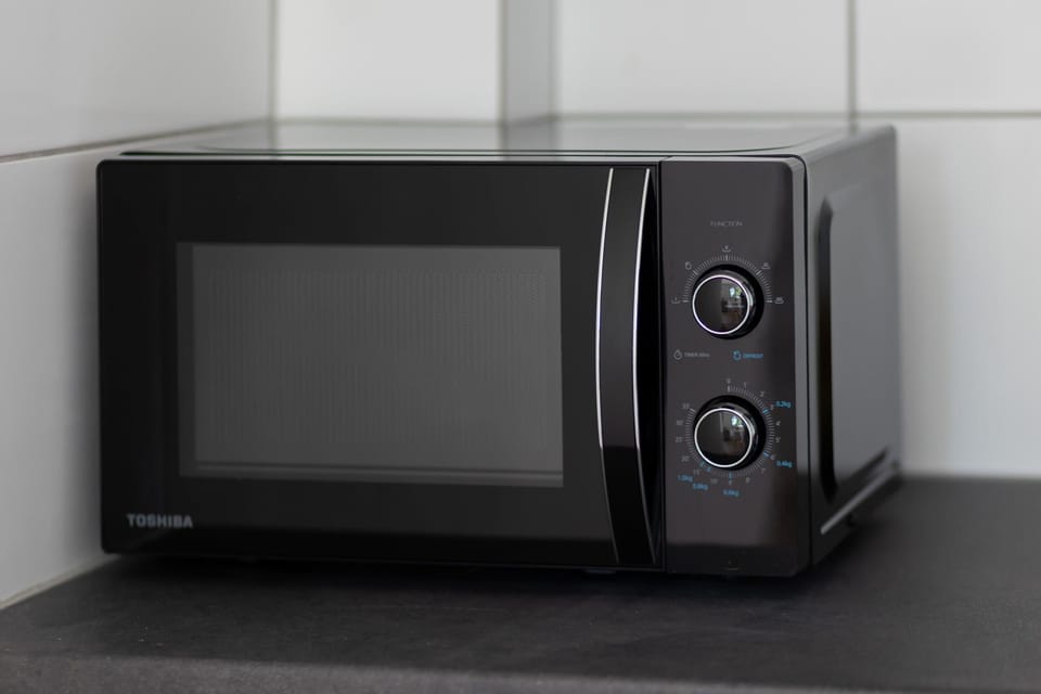 A microwave on the countertop for convenient meal preparation in the kitchenette.



