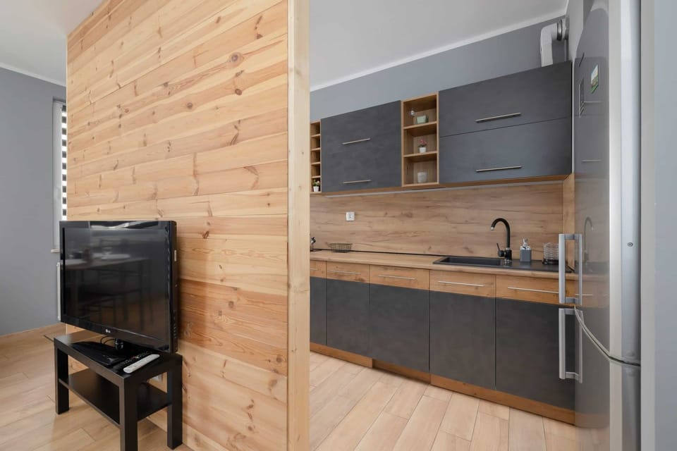A functional kitchen layout with plenty of counter space, wooden details, and stylish appliances.

