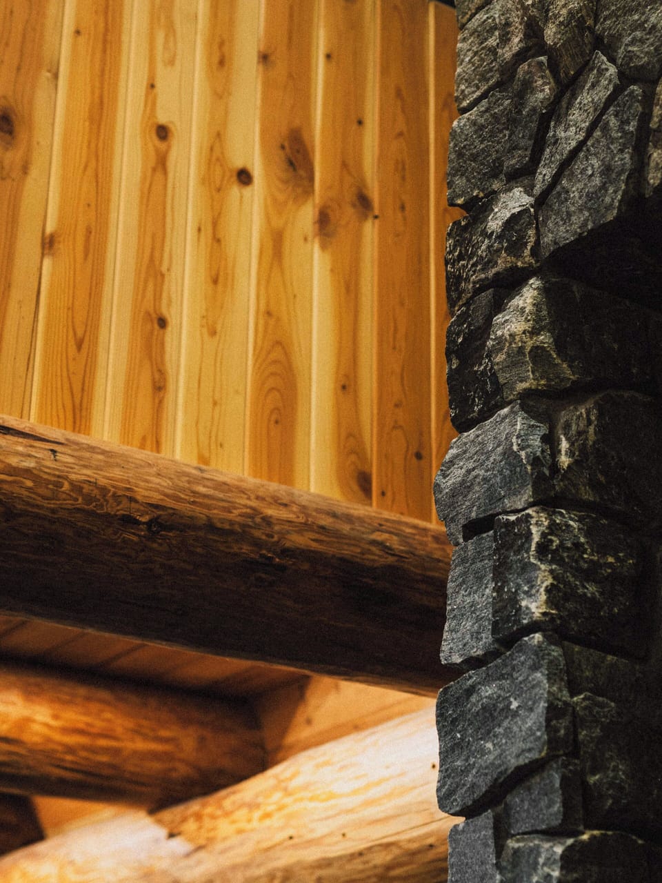 Warm wood accents and stone details create a cozy Scandinavian-inspired atmosphere.