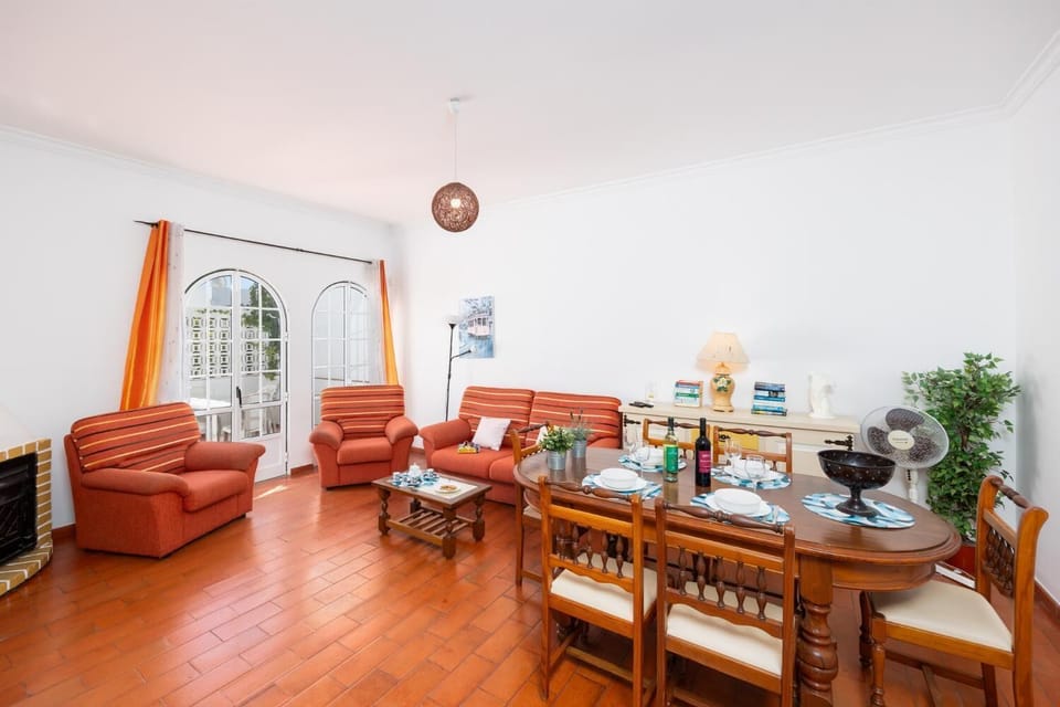 Living room with sofa, dining area, ornamental fireplace, WiFi internet, and satellite TV
