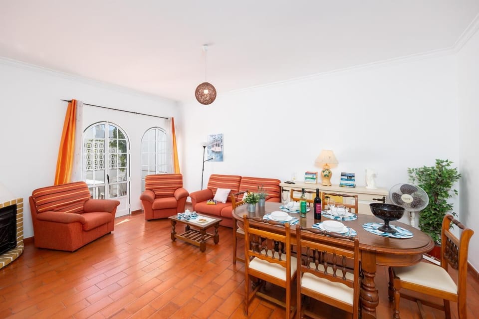 Living room with sofa, dining area, ornamental fireplace, WiFi internet, and satellite TV