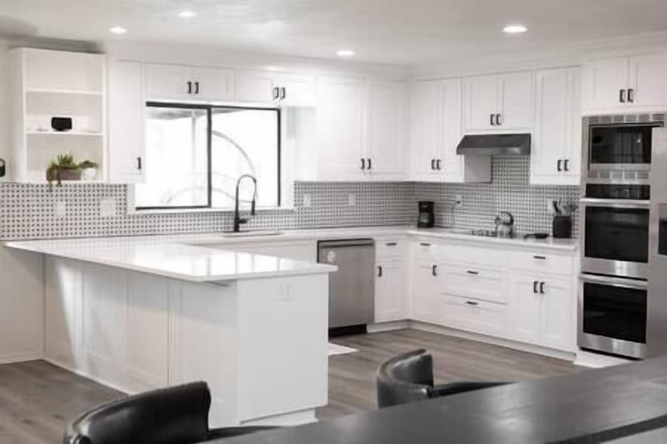 Pristine kitchen with plenty of built-in cabinets and quartz countertops