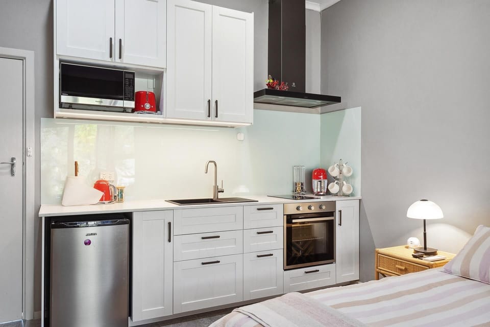 Well appointed kitchen with oven, microwave, induction hobs and rice maker.