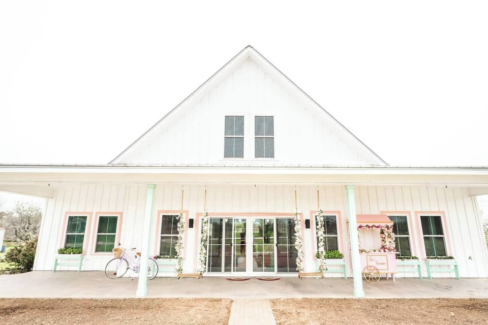 Front view of house with large front patio, sliding doors, and 25' front windows