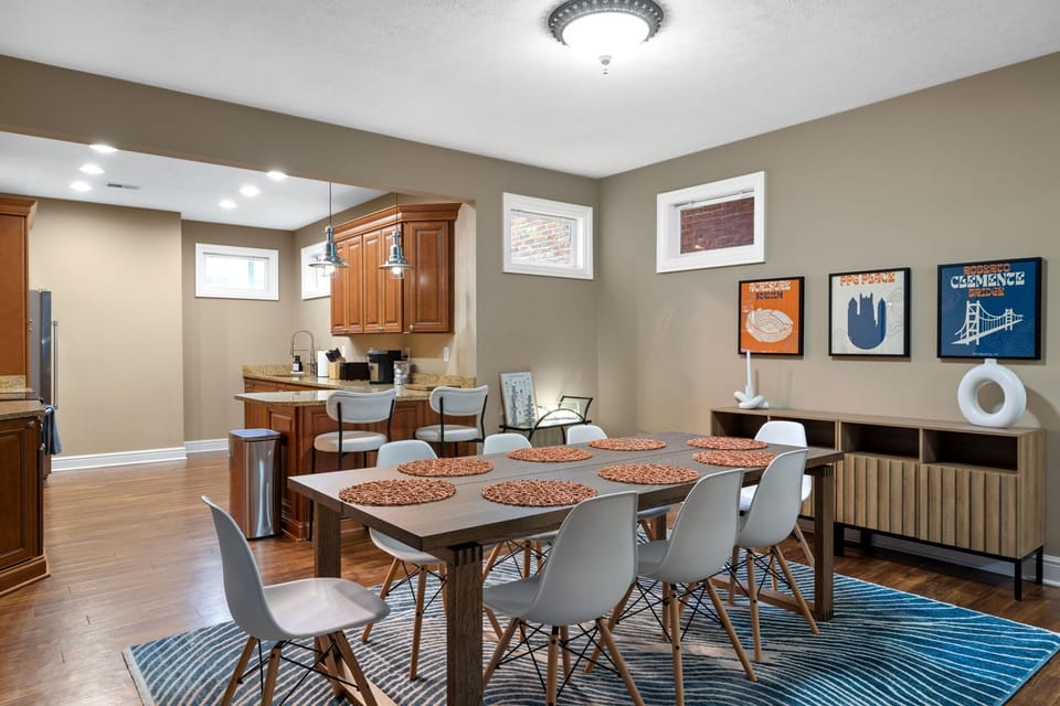 Dining area with table mats and spacious kitchen area 