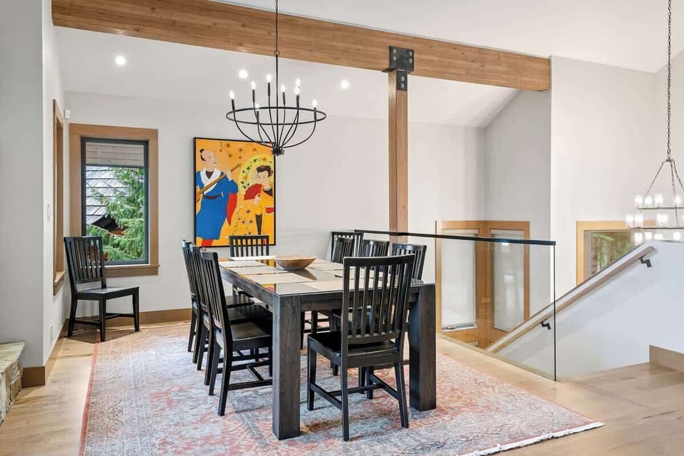 - Elegant dining space with modern chandelier and mountain charm  
- Large table seats family and friends for shared meals  
- Warm lighting and artwork elevate every dinner gathering  