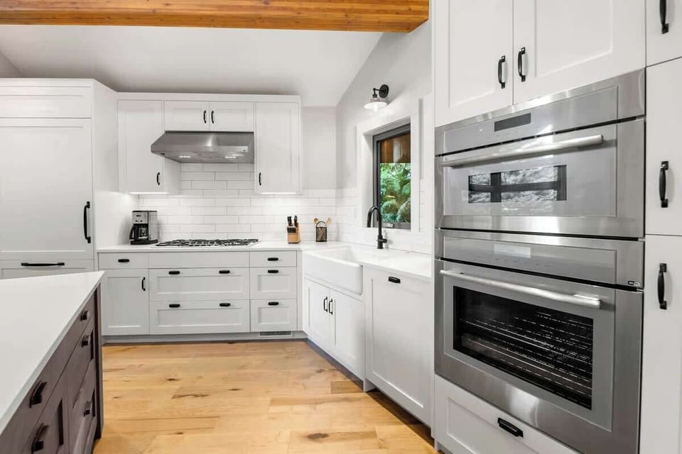 - Bright modern kitchen with stainless steel appliances and sleek design  
- White cabinetry and wood accents blend classic and contemporary style  
- Fully equipped for cooking hearty meals or quick mountain breakfasts  