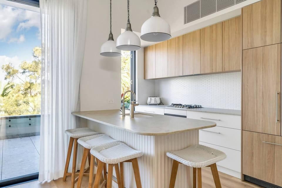 Kitchen breakfast bar and generous kitchen opening to terrace