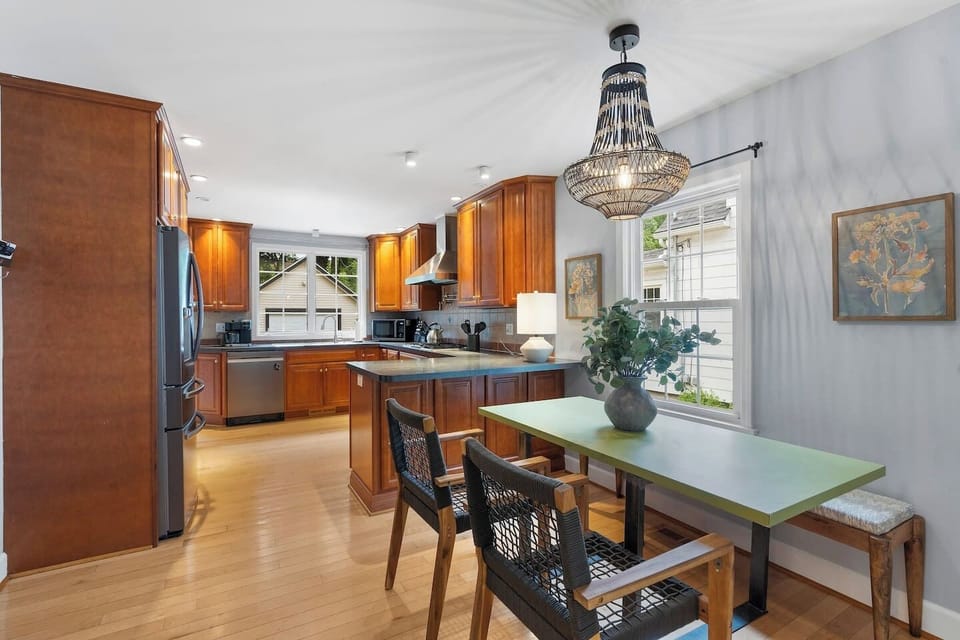 This modern dining area is adjacent to the kitchen so you can enjoy your meal right away.