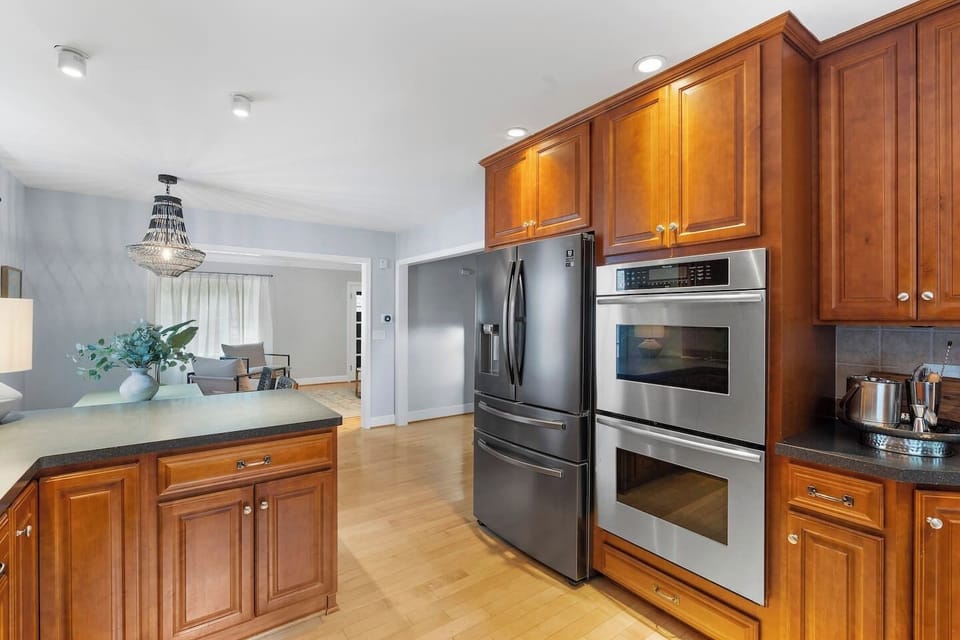 This fully equipped kitchen, which includes a fridge, two built-in wall ovens, a dishwasher, and a gas stove, will thrill food connoisseurs.