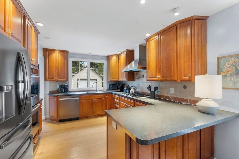 This fully equipped kitchen, which includes a fridge, two built-in wall ovens, a dishwasher, and a gas stove, will thrill food connoisseurs.