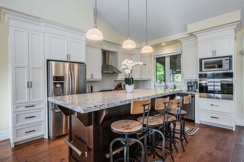 Stylish, modern kitchen with island seating, stainless appliances, and ample space for entertaining.