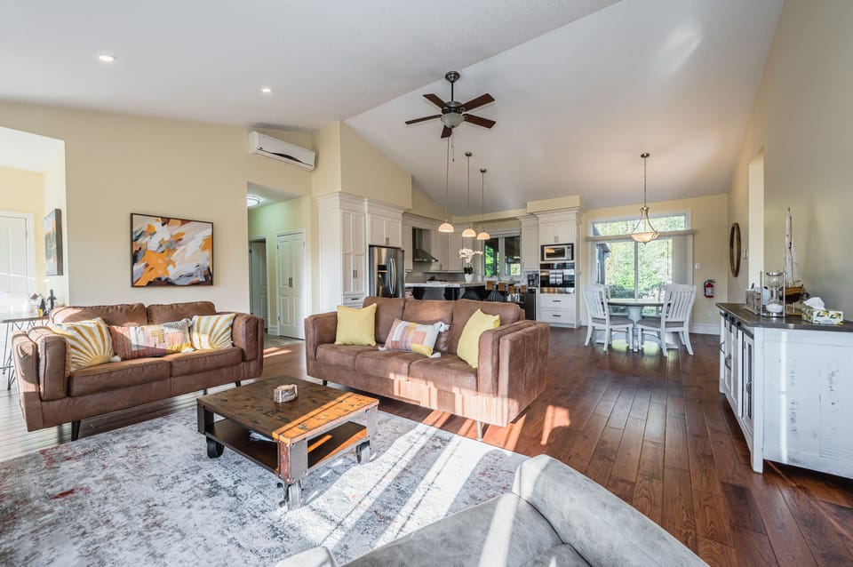 Spacious living and dining area with vaulted ceilings and warm tones—ideal for memorable getaway moments.