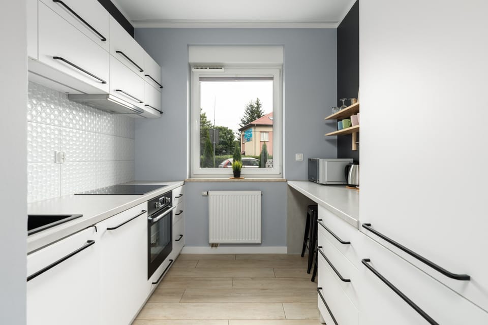 A wide-angle view of the kitchen emphasizing its bright and organized layout.

