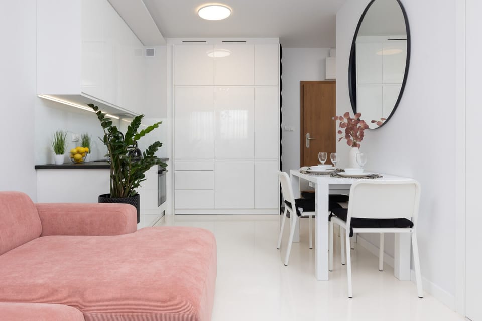 Another view of the living and dining area, emphasizing its spacious and airy layout.


