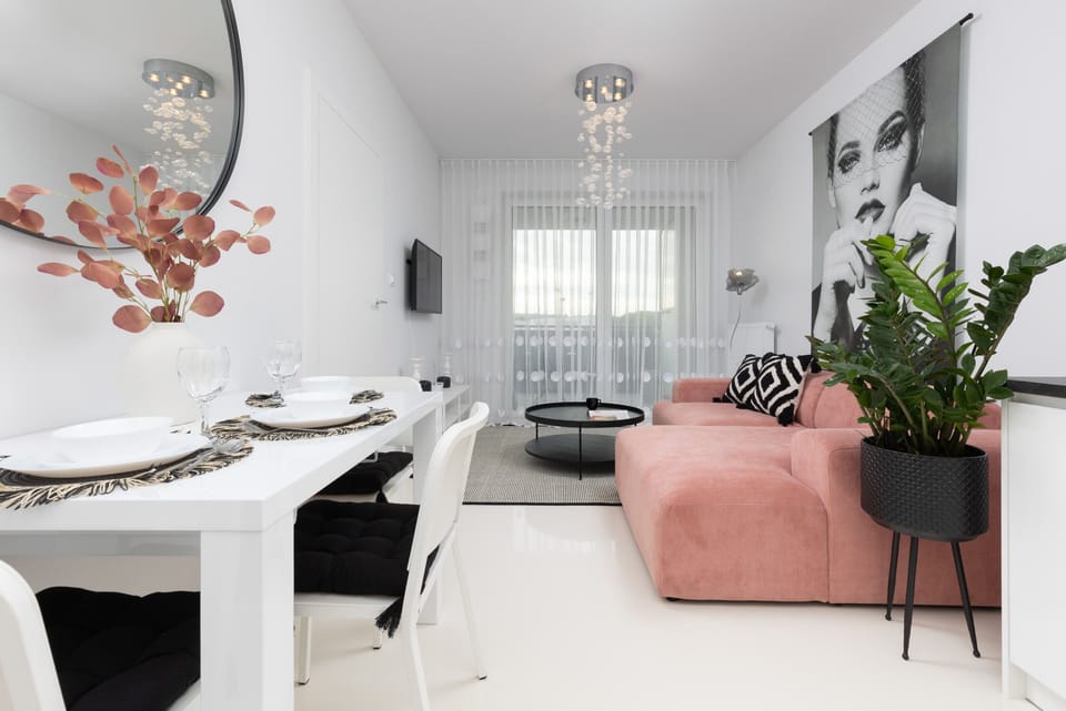 A dining area with a white table, elegant decor, and seamless integration with the living room.

