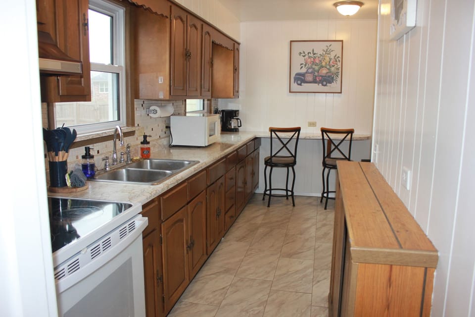 A fully stocked kitchen with plenty of counter space — perfect for easy meals, morning coffee, and gathering while you cook.