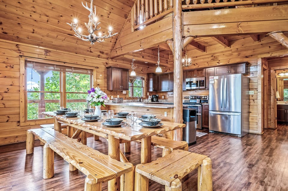Large, open concept chef's kitchen overlooks the wraparound porch on the main level. Stainless steel appliances, a double oven, bar top and fully loaded amenities for cooking family meals.