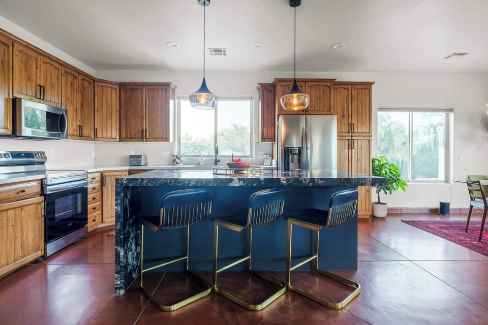 The fully-equipped kitchen with stainless steel appliances is ready for your culinary creations.